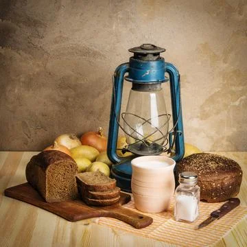 Milk in ceramic ware, rye bread, cutting board, salt and salt salt, onions Stock Photos