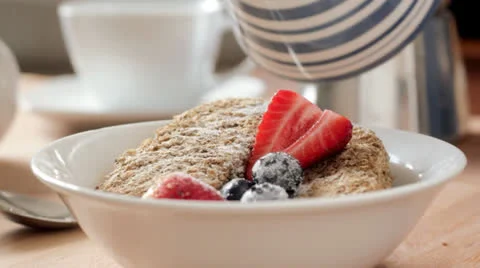 Milk on cereal for breakfast Stock Footage 23892655