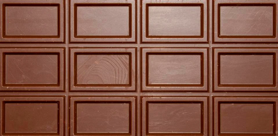 Milk chocolate background with rectangular block pattern. Stock Photos