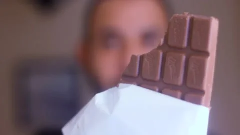 Milk chocolate bar with missing bite 스톡 동영상 143912009