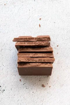 Milk chocolate chunks on light background Stock Photos