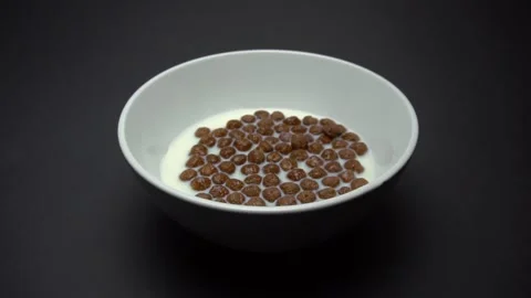 Milk with Chocolate Corn Balls. Slow Motion Stock Footage 86995424