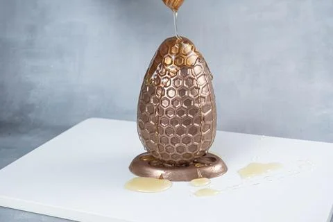 Milk chocolate Easter egg filled with Brazilian honey cake 2. Stock Photos