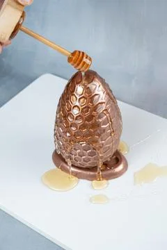 Milk chocolate Easter egg filled with Brazilian honey cake 4. Stock Photos
