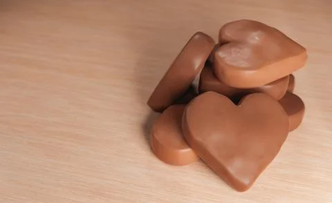 Milk chocolate hearts on table Ilustração Stock