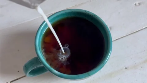 Milk in coffee Stock Footage 251540188