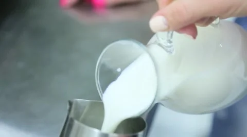 Milk for coffee is poured into a vessel Stock Footage 63144795