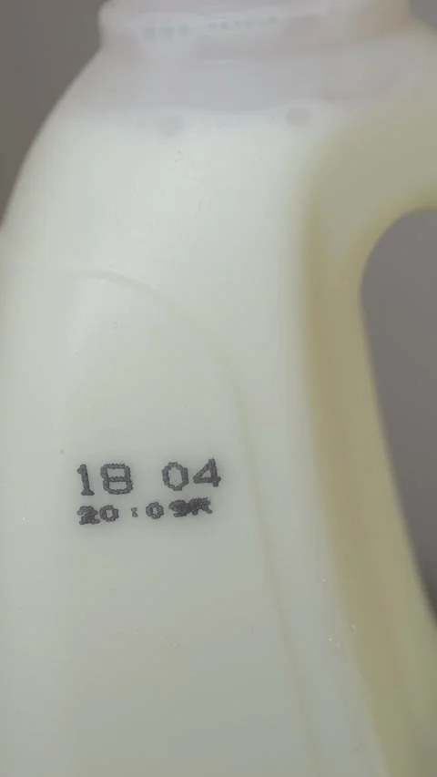 Milk container with visible expiry date, emphasizing smart shopping and informed Video stock 332903617