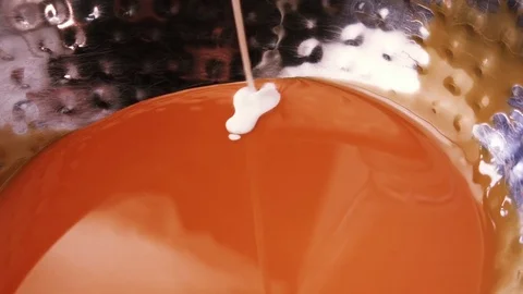 Milk, cream of thin streams pour from a bowl with condensed milk, caramel cream. Stock Footage 79252029