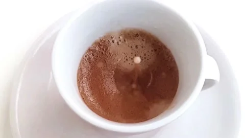 Milk Drop Falling In A Cup Of Coffee. Slow Motion Stock Footage 168261376