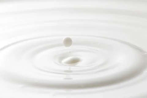 Milk drop with ripples Stock Photos