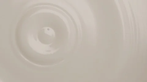 Milk dropping in super slow motion into a bowl of milk Stock Footage 88050468