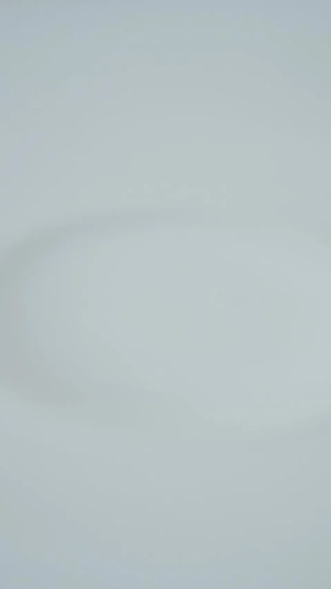 Milk Drops in a Vertical Video Stock Footage 250030665