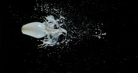 Milk Exploding and Splashing on Black Background, Slow Motion 4K Stock Footage 120040589