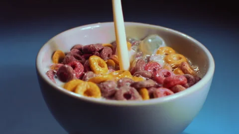 Milk falls on the cereal in the bowl Stock Footage 274263173