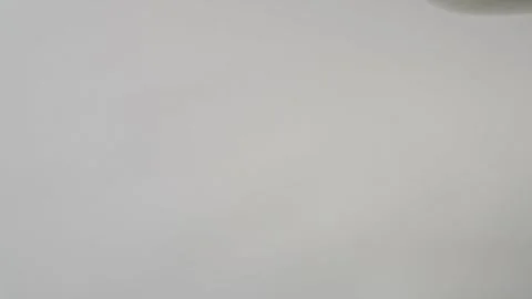 Milk flows in a trickle on a white background in close-up. Stock Footage 278208681