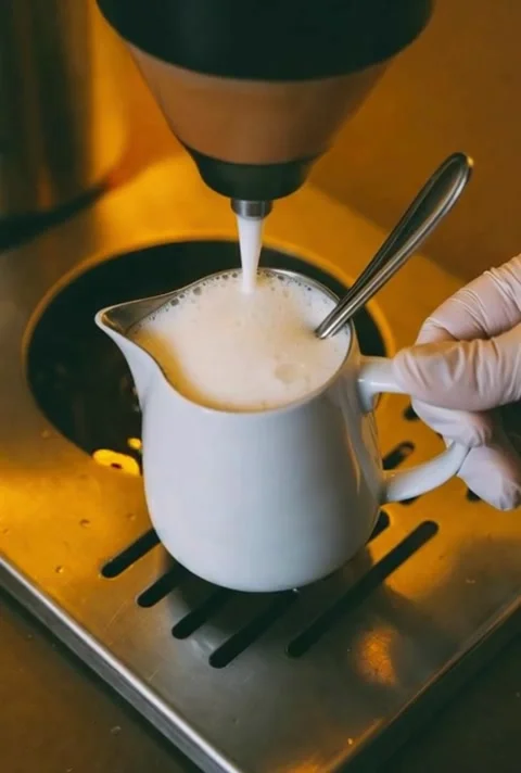 Milk Frothing Process With Gloved Hand and Spoon in Coffee Preparation Dyna.. Stock Footage 320594921