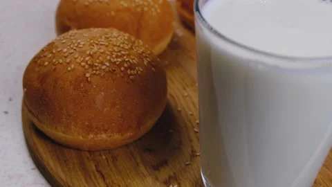 Milk in glass on the background of buns Stock Footage 167284621