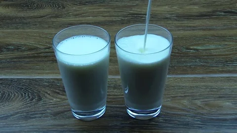Milk into glass cups Stock Footage 79311431