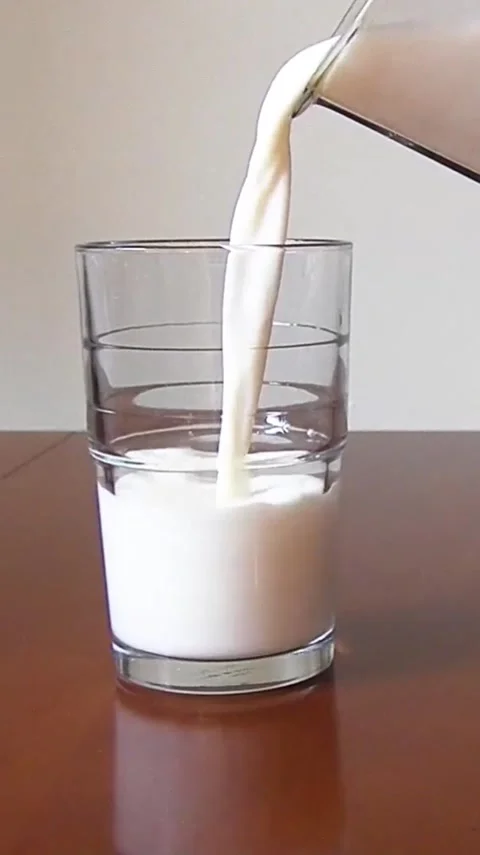 Milk into Glass Stock Footage 303390236