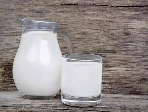 Milk in glassware on rustic table Stock Photos