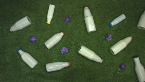 Milk on the grass. Top view. Video stock 122588045