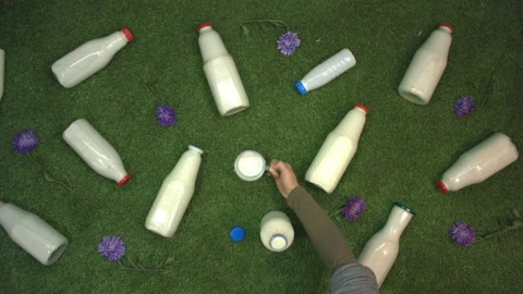 Milk on the grass. Top view. Slow motion 2x. Видео 122588249