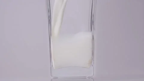 Milk for healthy future. Super slow motion shot of pouring, splashing fresh milk Stock Footage 147411972