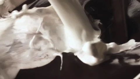Milk hot chocolate pouring splashing HD slow motion close-up video. Dairy cocoa Stock Footage