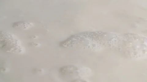 Milk liquid white surface full hd slow-motion close-up video Dairy bubbles Stock Footage 83103399