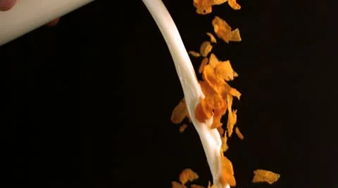Milk mixed with cereals pouring Stock Footage
