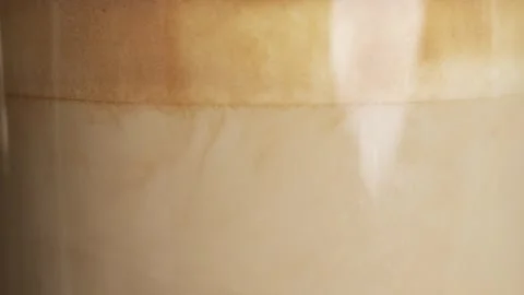 Milk is mixed with espresso coffee in a cup Stock Footage 277879232