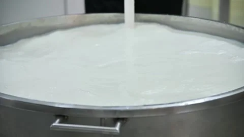 Milk mixing process in large stainless steel container with liquid flow Stock Footage 337229294
