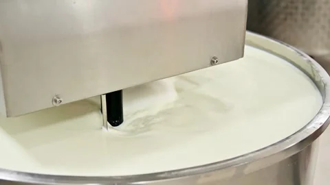 Milk mixing separator in operation, creating a smooth blend in large container Stock Footage 337229167