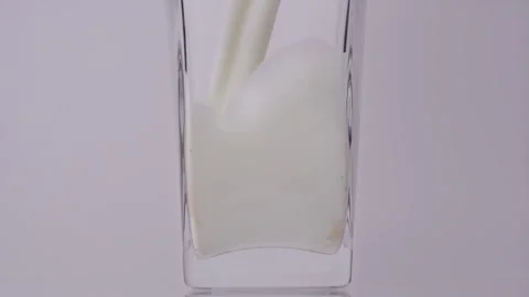 Milk is a necessary. Super slow motion shot of pouring, splashing fresh milk 스톡 동영상 147412934
