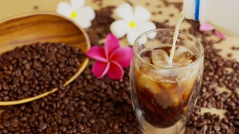Milk From Plastic Bottle Pouring Into Iced Coffee Glass. Vídeo Stock 197014237