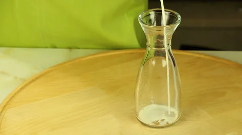 Milk poured into the bottle Stock Footage 61879656