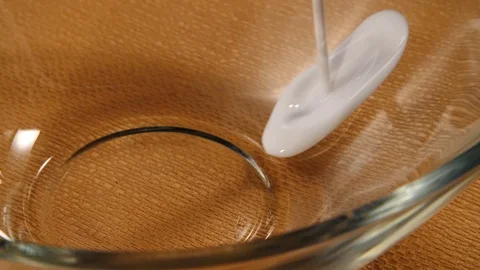 Milk poured into a bowl Stock Footage 112887553