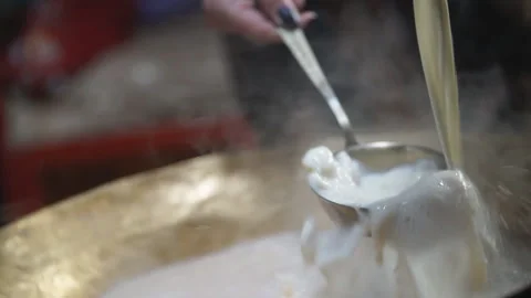 Milk is poured into a container with boiling milk Vídeos de archivo 96411019