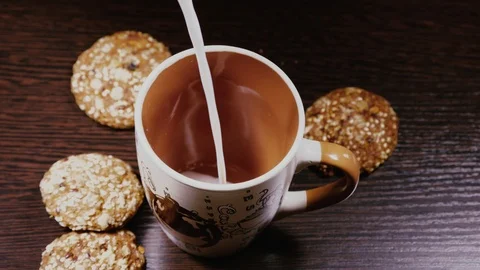 Milk poured into a Cup close-up Stock Footage 103163840