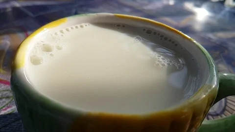 Milk is poured into the cup slow-motion shot Stock Footage 89255527