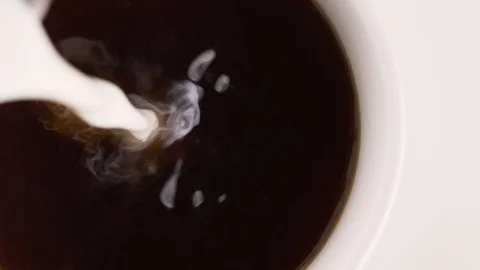 Milk is poured into a Cup of tea Video stock 128546698