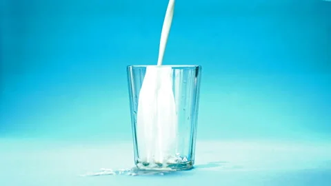 Milk is poured into a glass Stock Footage 120574265