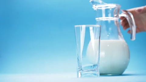 Milk is poured into a glass Stock Footage 120578138