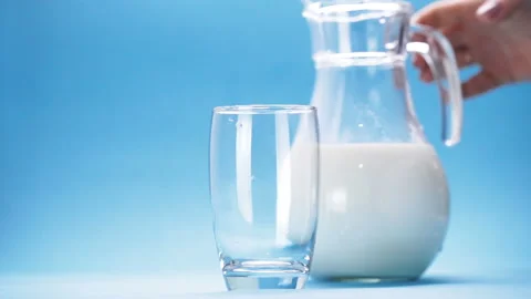 Milk is poured into a glass Stock Footage 120578155