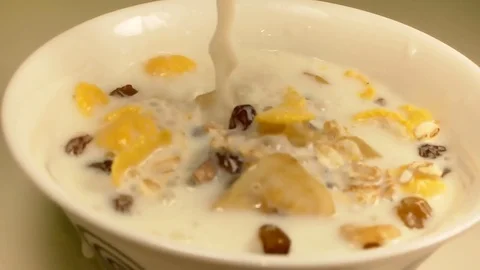 Milk is poured into muesli Stock Footage 80446482
