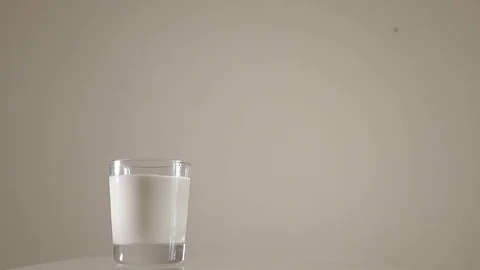 Milk is poured in a mug Stock Footage 73384792