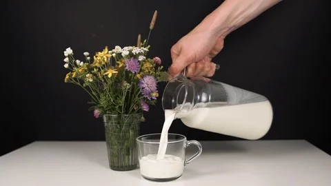 Milk is poured into a mug Stock Footage 93254999