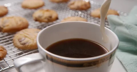 Milk poured into nice coffee cup with cookies 2000 fps Phantom Stock Footage 147199179