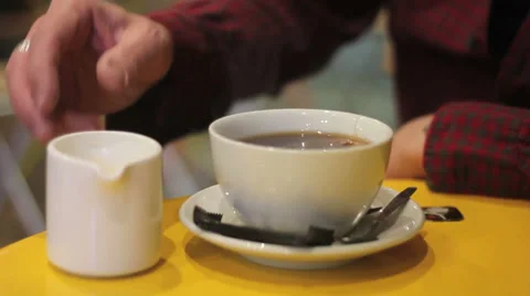 Milk is poured into tea in a cafe Stock Footage 34343925